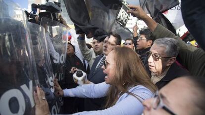 Protestors confront police in Quito.