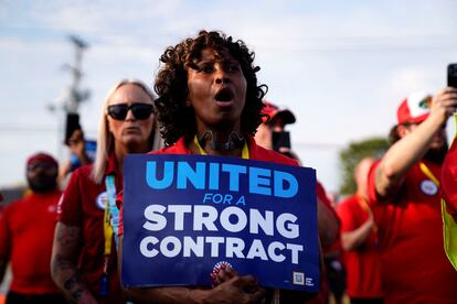 A Ford employee holds a sign during a UAW rally to support striking workers outside an assembly plant in Louisville, Kentucky