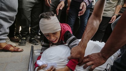 A child cries over the body of a relative after the Israeli attack on the Fahmi al-Jarjaw school in Gaza City on Monday.
