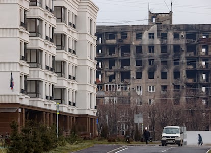 New homes built by the Russian government right across from a damaged building on the other side of Kuprina Street, in December 2022.