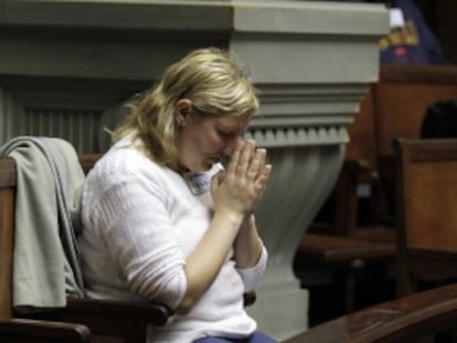 Una mujer reza mientras asiste al debate en el Senado de Uruguay.