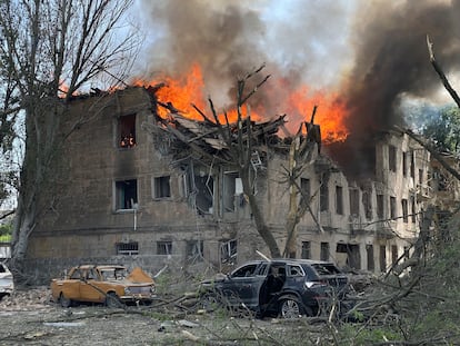 Firefighters hose down a Policlinic following a Russian attack in Dnipro, Ukraine