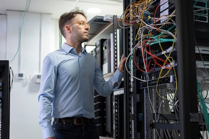 José Luis Hernández Ramos next to a cluster of computers at the University of Murcia, Spain.