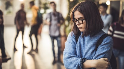 A teenager in a school hallway.