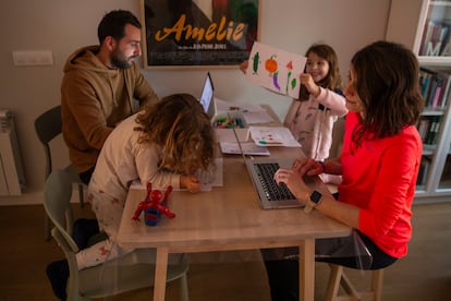 Parents working while looking after their children in Madrid.